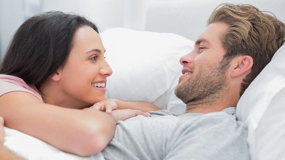 Happy woman with a man in bed